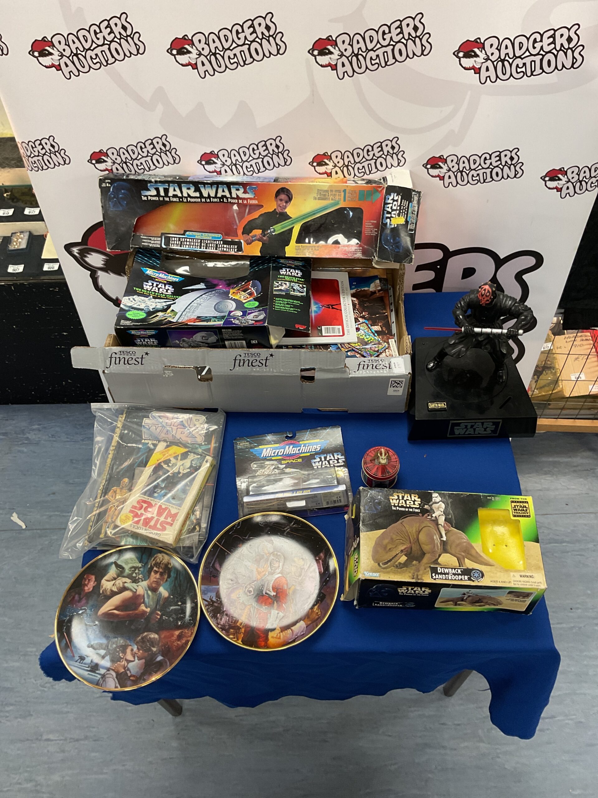 418 Lot of Star Wars memorabilia and collectibles incl. empty lightsaber, death star deluxe, and dewback and sandtrooper boxes
