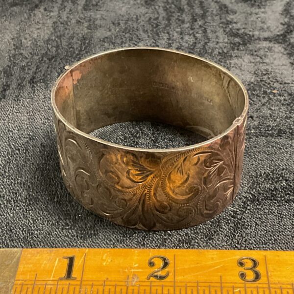 Intricate engraved sterling silver hinged bracelet with hallmarking.