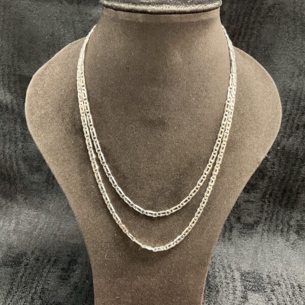 Two sterling silver figaro chain necklaces on display.
