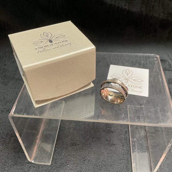 Sterling silver spinner ring size S with energy stone detail.