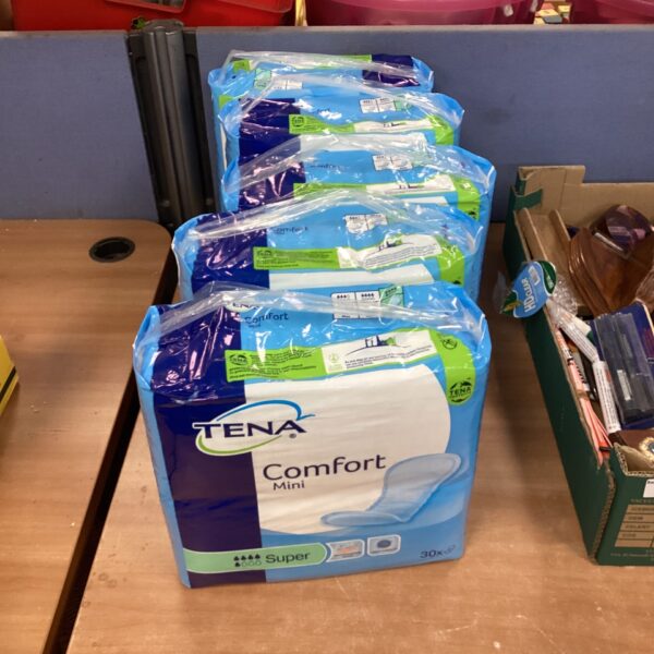 Lot of five unopened packs of Tena Super Comfort Mini pads.