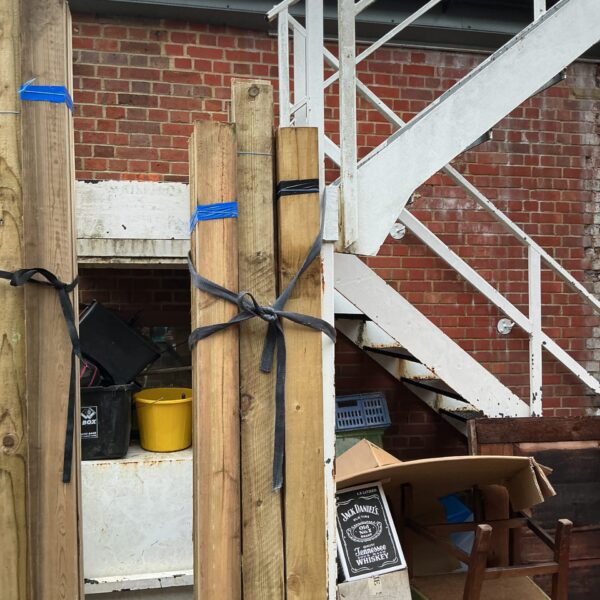 Three bundles of 7ft timber secured with straps outdoors.