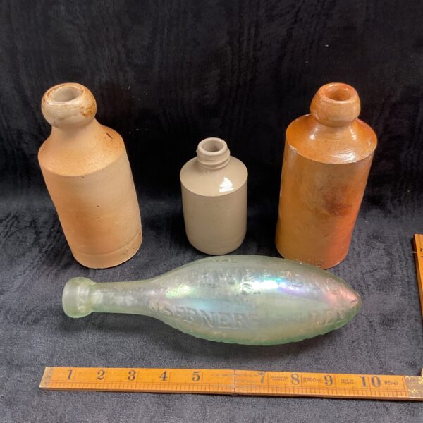 Victorian stoneware bottles and a Schweppes glass bottle in a lot.