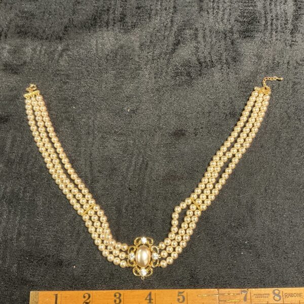Vintage multi-strand faux pearl necklace with ornate clasp.