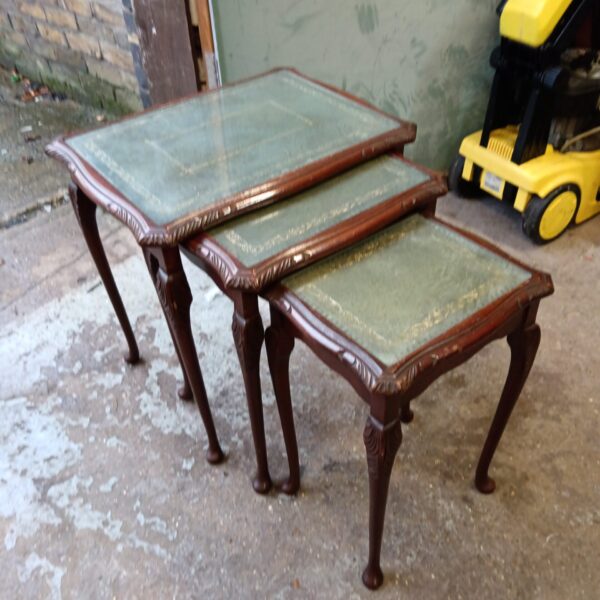 Vintage nest of tables with green leather tops and wood frames.
