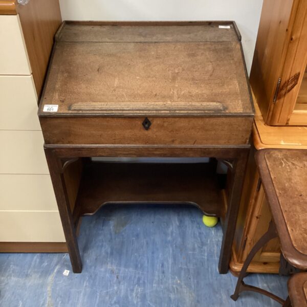 Vintage mahogany bureau with a sloping writing surface.