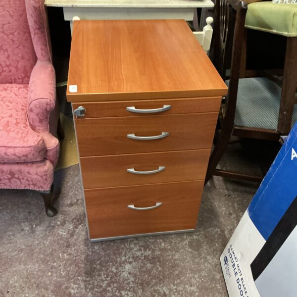 Vintage metal filing cabinet with three drawers for office storage.