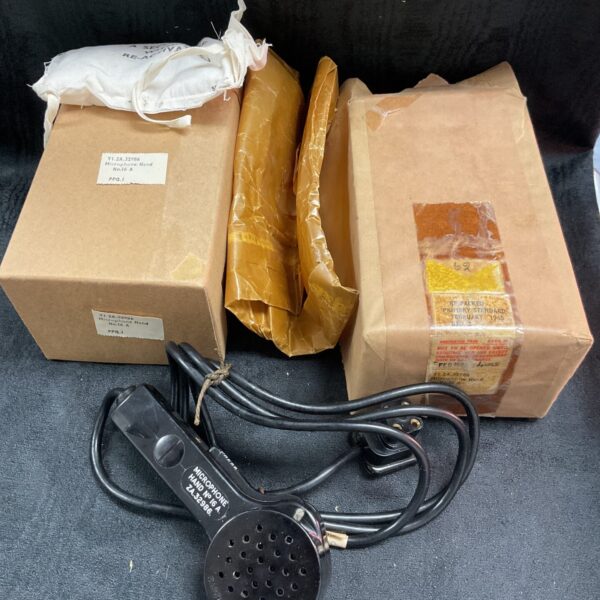 Vintage handheld microphone in original 1965 packaging.