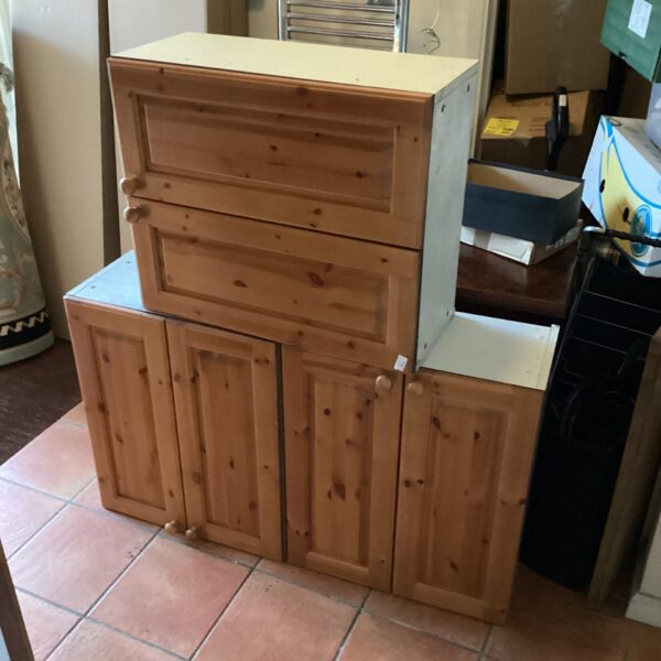 Three vintage pine kitchen cupboards for kitchen storage.