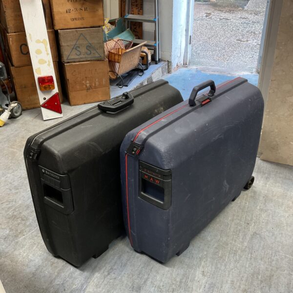 Two vintage Samsonite hard shell suitcases in a room.