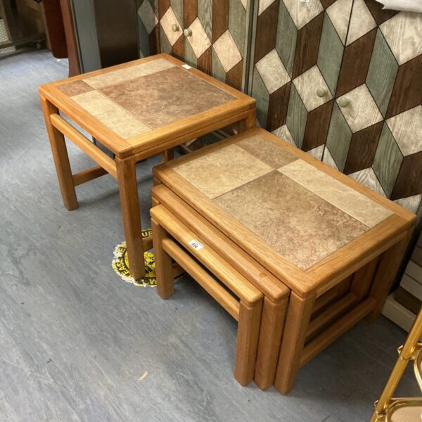 Vintage nest of tables with tile tops and wooden frames.
