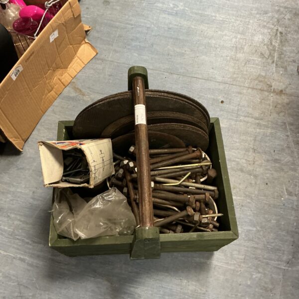 Vintage wooden tool box filled with bolts and cutting discs.