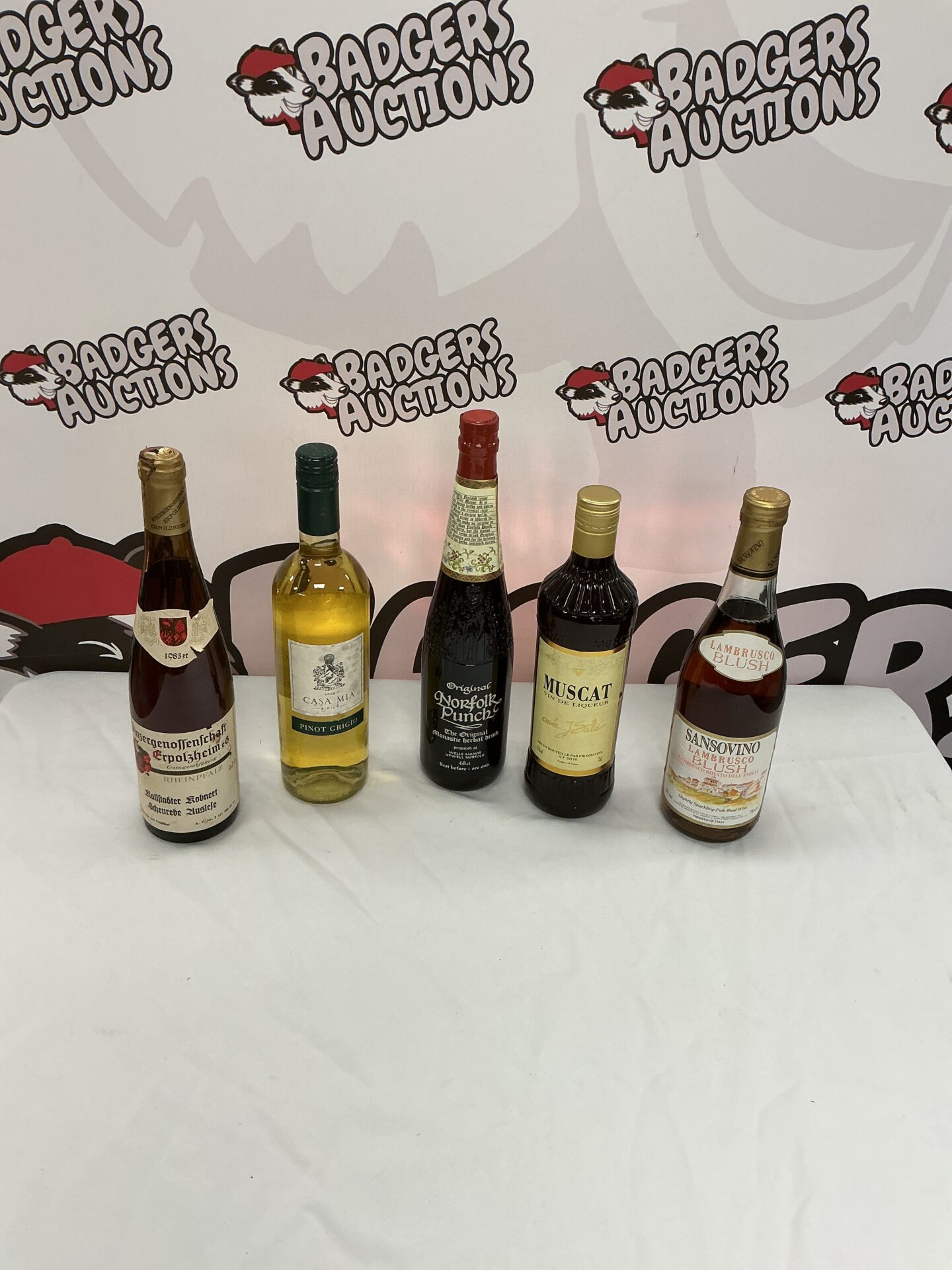 895 Four bottles of wine and a bottle of Norfolk Punch