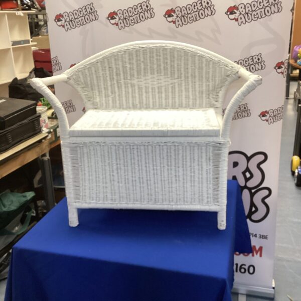 White painted wicker storage seat with lift-up storage for hallway or bedroom.