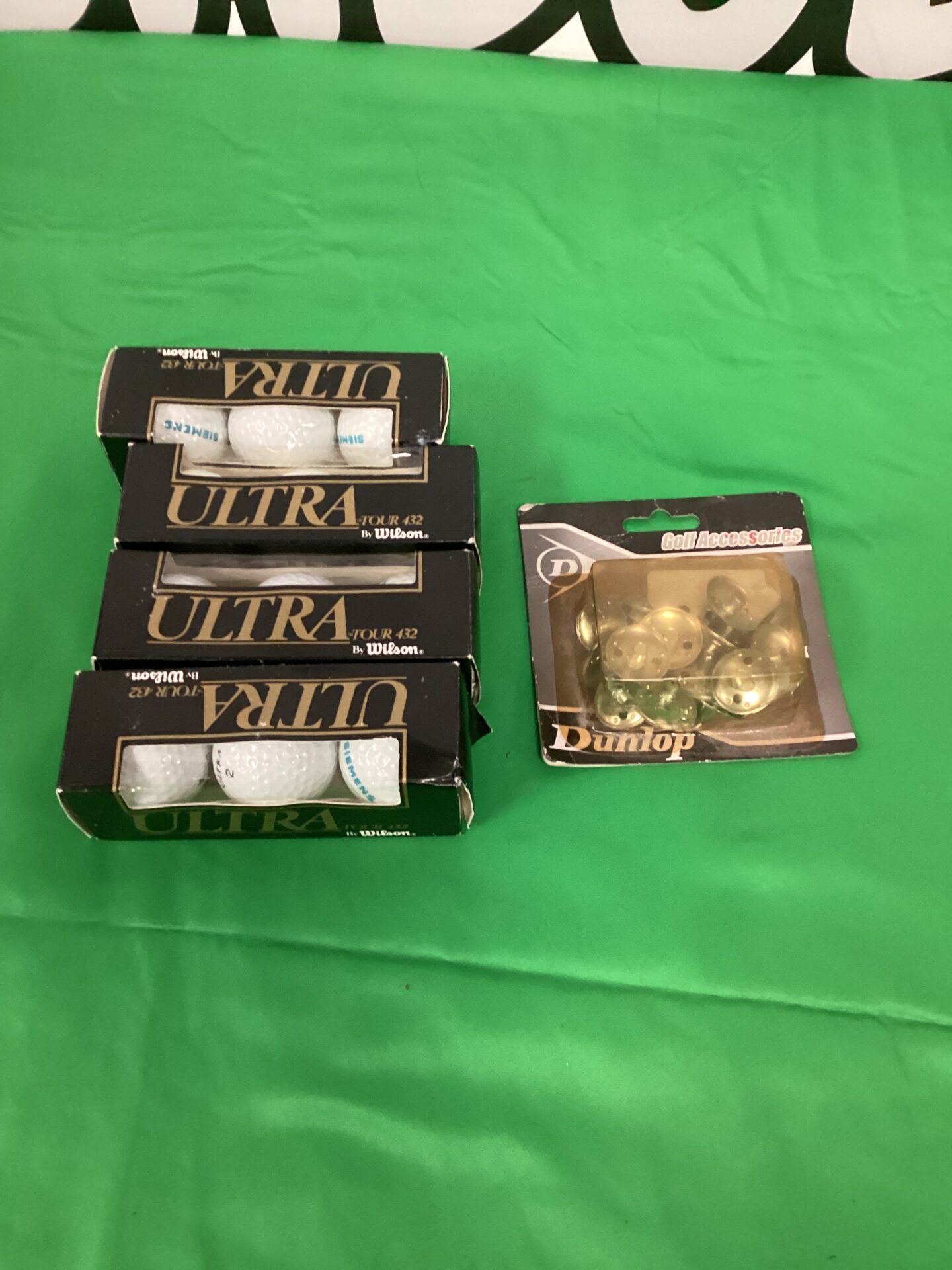 598 Four packs of Wilson ultra tour 432 golf balls and a set of Dunlop spikes