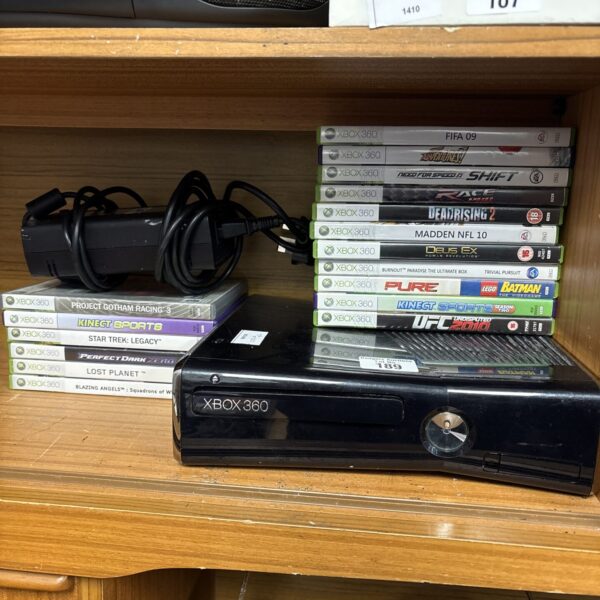 Xbox 360 console with games, retro gaming system.
