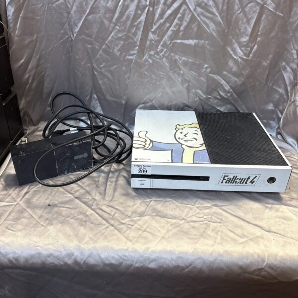 Black Microsoft Xbox One console with power supply.