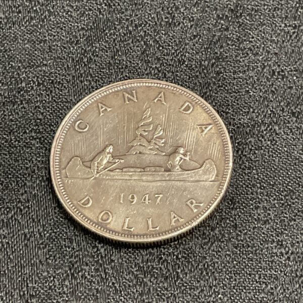 1947 Canadian silver dollar coin, obverse side, detailed design.