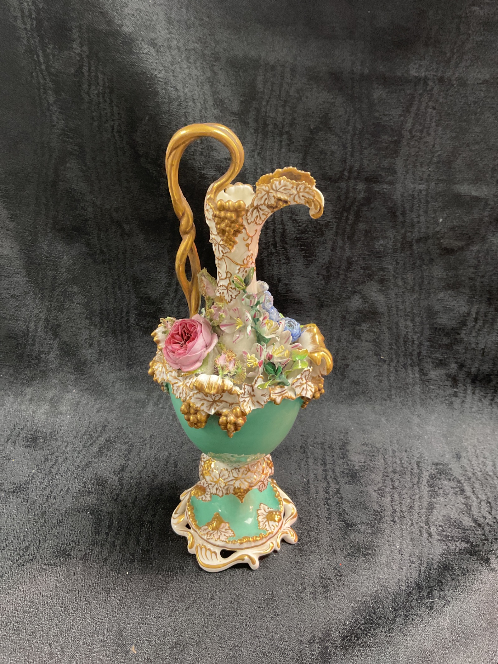 940 19th Century coalport coalbrookdale style rococo revival flower encrusted on turquoise ground with gildingbto handle and base appro 10” tall