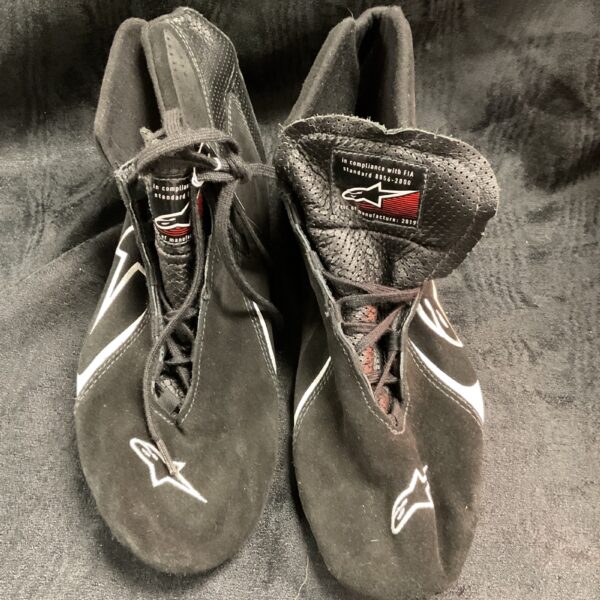 Pair of used Alpinestars racing boots, motorsport footwear.