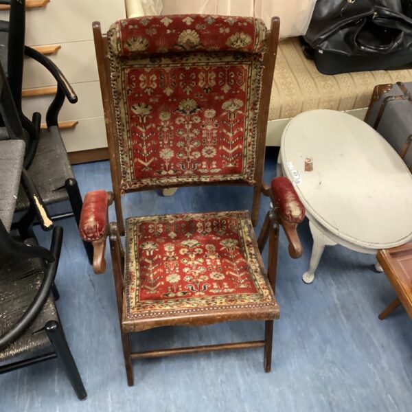Antique Jas Shoolbred folding chair with patterned upholstery.