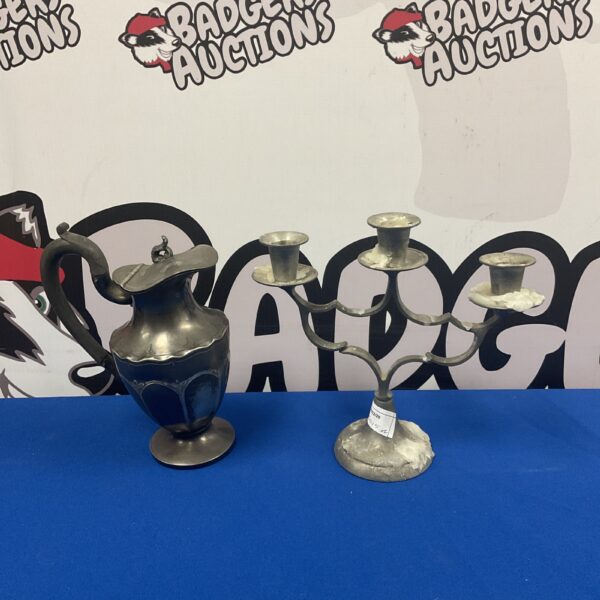 Antique pewter jug and three-headed candelabra set for collectors.