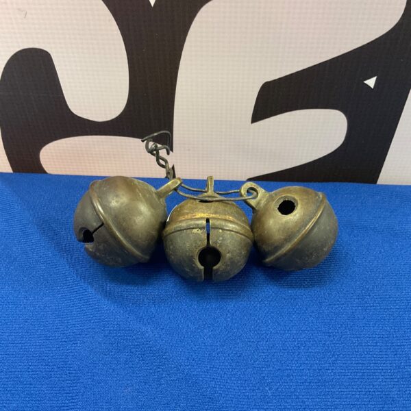 Antique sleigh bells, a set of three vintage crotal harness bells.