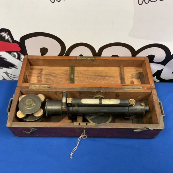 Antique theodolite in a wooden carrying case, vintage surveying instrument.