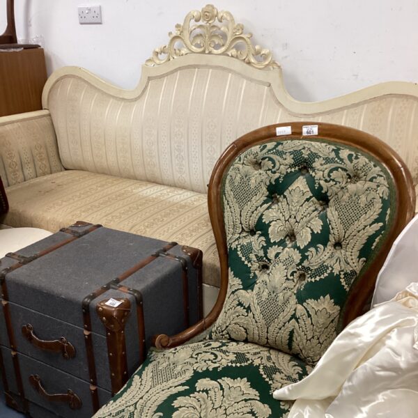 Antique Victorian sofa with patterned upholstery and mahogany frame.