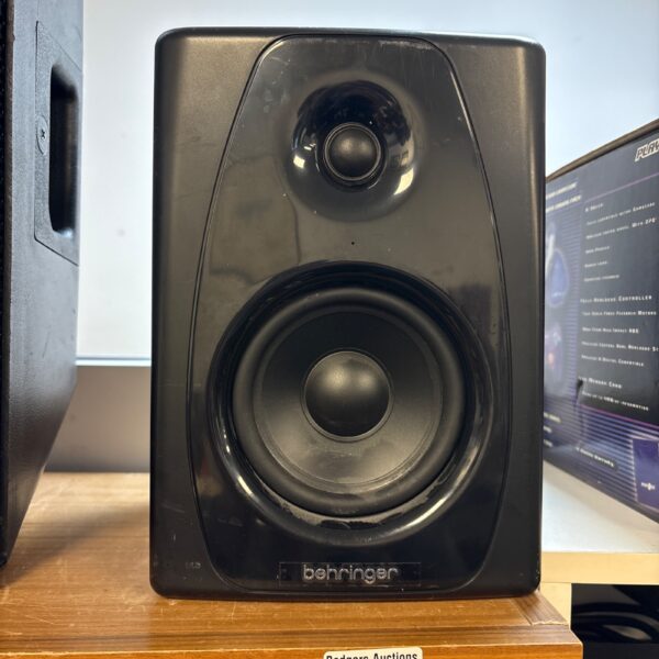 Black Behringer studio monitor speaker for music production.