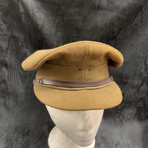 Vintage British Army officer cap displayed on a mannequin head.