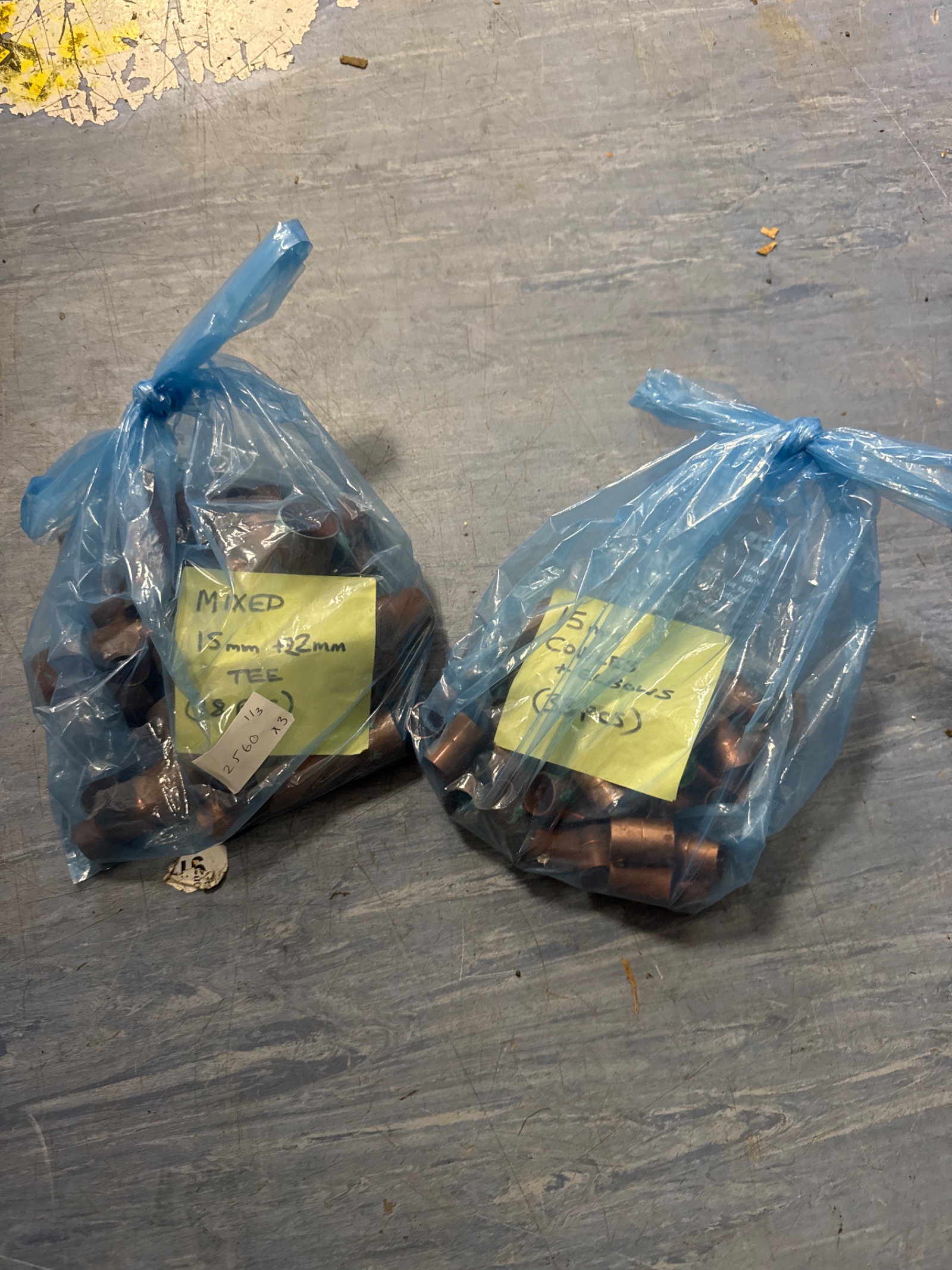 1111 Two bags of copper plumbing fittings inc 15mm + 22mm couples, elbows & tee pieces with bag of pipe clips