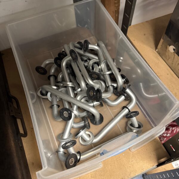 Mixed lot of brushed steel cupboard door handles for furniture.