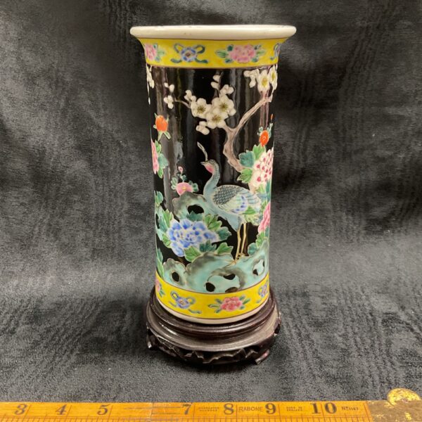 Front view of a vintage Chinese Famile Noir vase with peacock design.