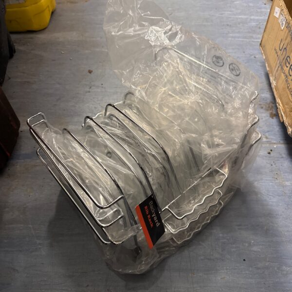 Five new metal BBQ rib racks still in packaging.
