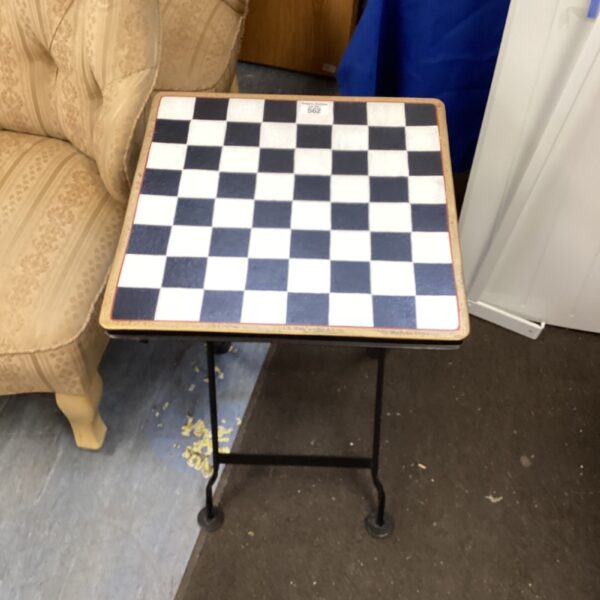 Chequered folding chess table for garden or patio use.