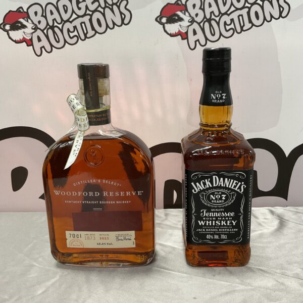 Sealed bottles of Jack Daniel's and Woodford Reserve whiskey for collectors.