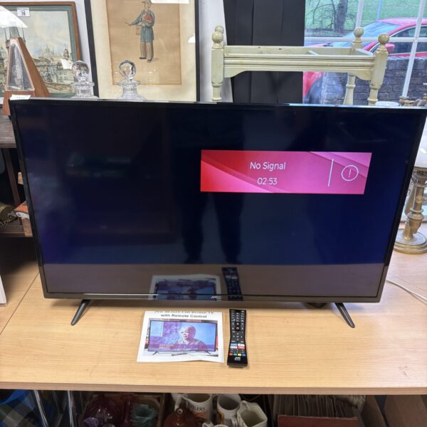 JVC 40 inch smart TV with remote control for sale.