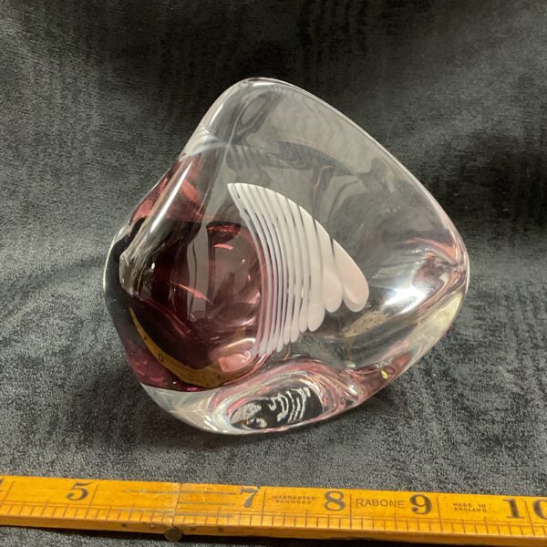 Purple and clear Karlin Rushbrooke glass ornament on ruler.