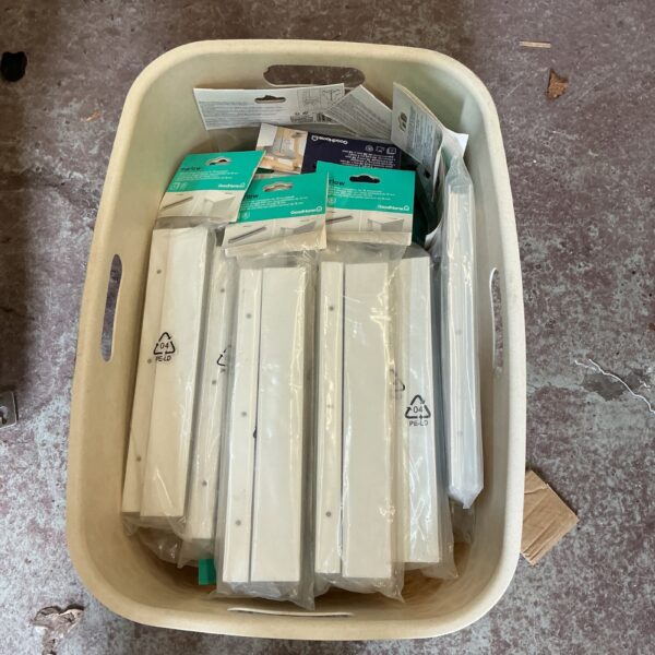Lot of white kitchen worktop joining strips in packaging.