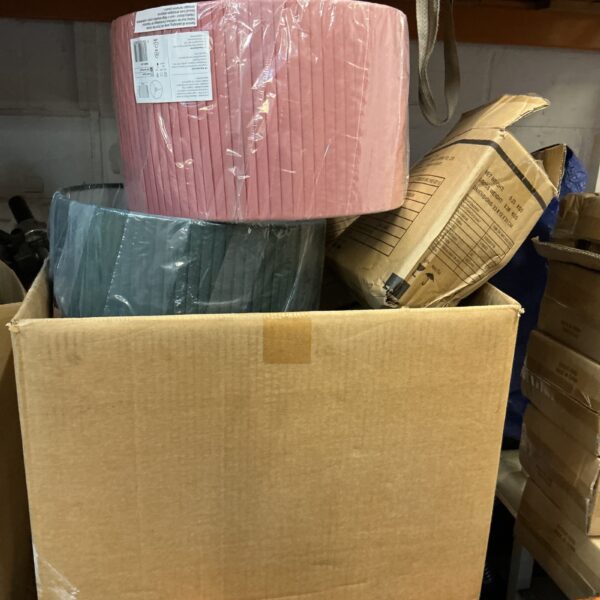 Box of new pale pink lampshades for home lighting.