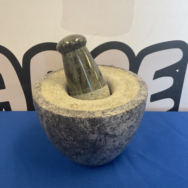 Large granite pestle and mortar for grinding spices and herbs.