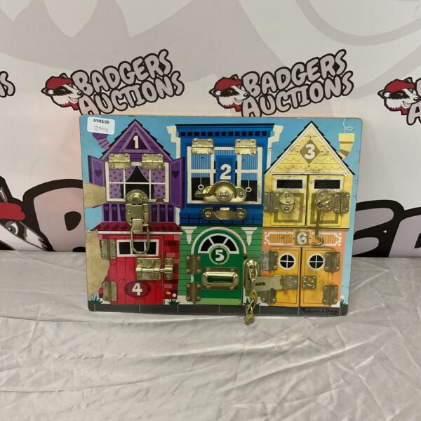 Melissa & Doug wooden door lock board for developing fine motor skills.