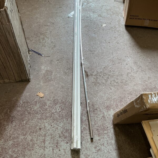 Polished metal hanging rail for wardrobe storage.