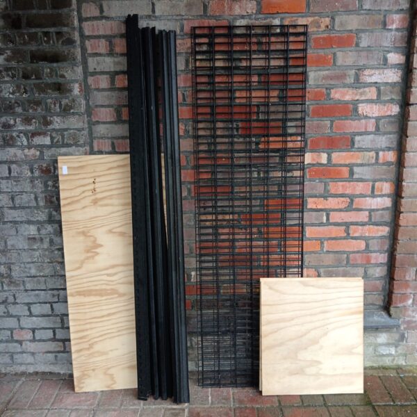 Heavy duty metal racking system with wooden shelving for workshop storage.