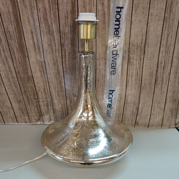Vintage metallic glass table lamp with textured finish.