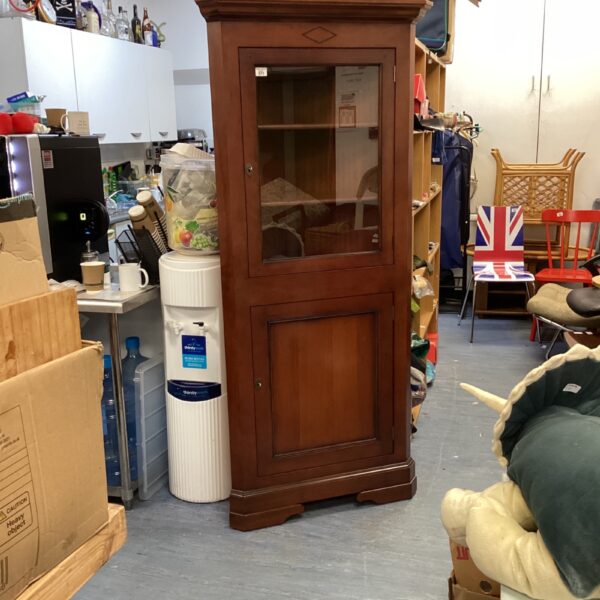 Vintage Multiyork cherry wood corner cabinet for display and storage.