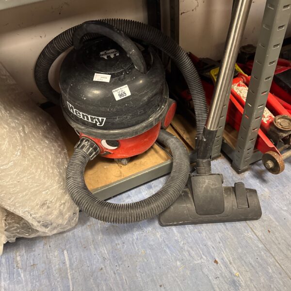 Red Numatic Henry Hoover with pole attachment, vintage vacuum cleaner.