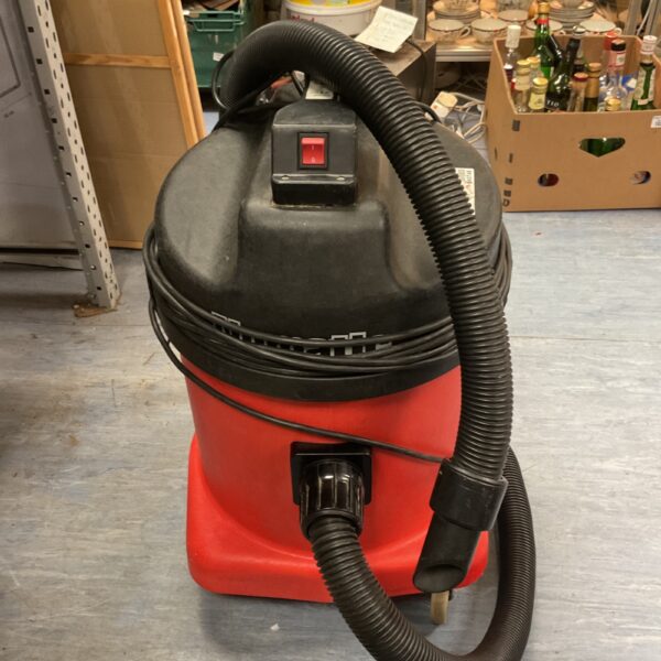 Red Numatic industrial vacuum cleaner with flexible hose.