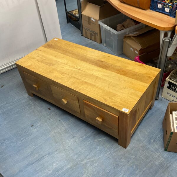 Rustic oak coffee table with six drawers for living room storage.